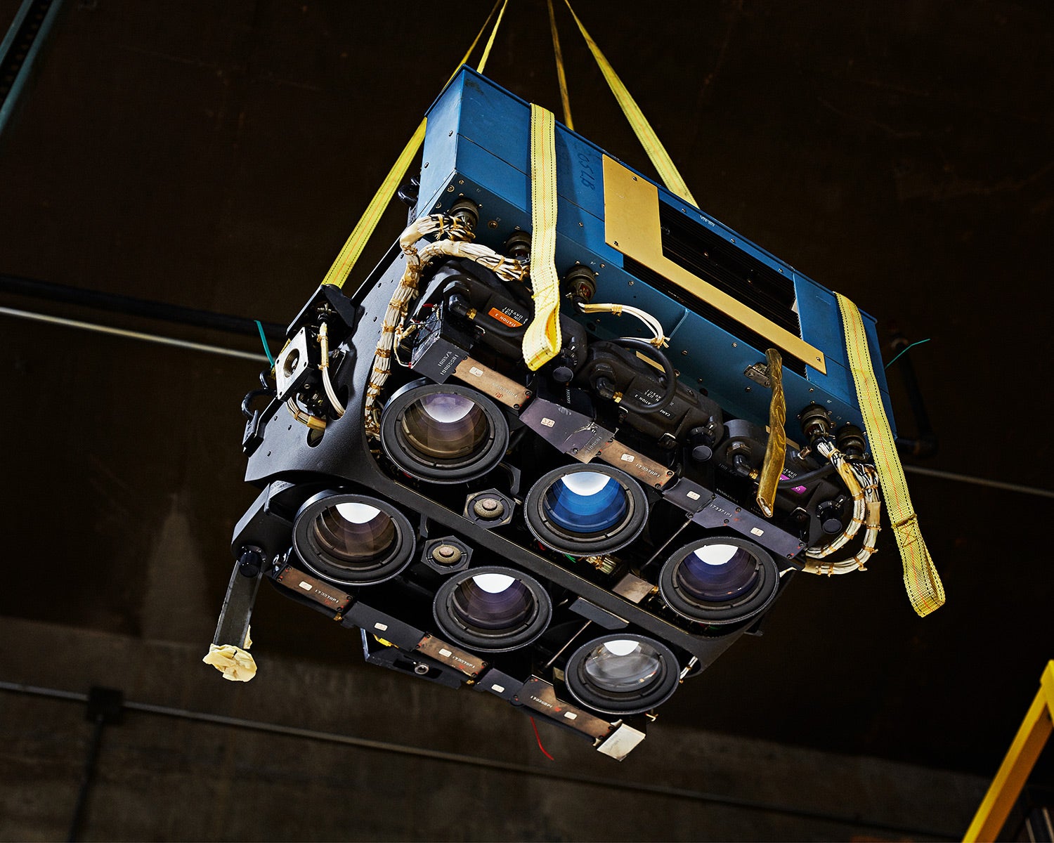 a NASA rig used by the US Forest Service in 1970s, hanging in the air by straps inside a vintage camera museum 