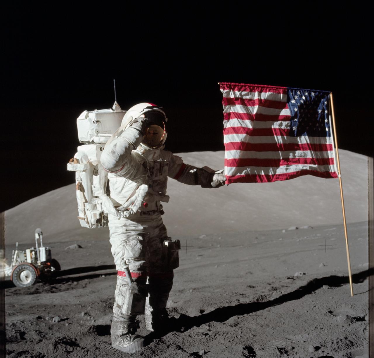 An astronaut salutes the american flag