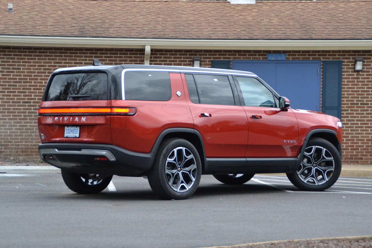 The Rivian SUVâs cargo area is spacious and opens with a Range Rover-like split door, with an upper hatch covering most of the opening and a small lower tailgate providing convenient seating when open.