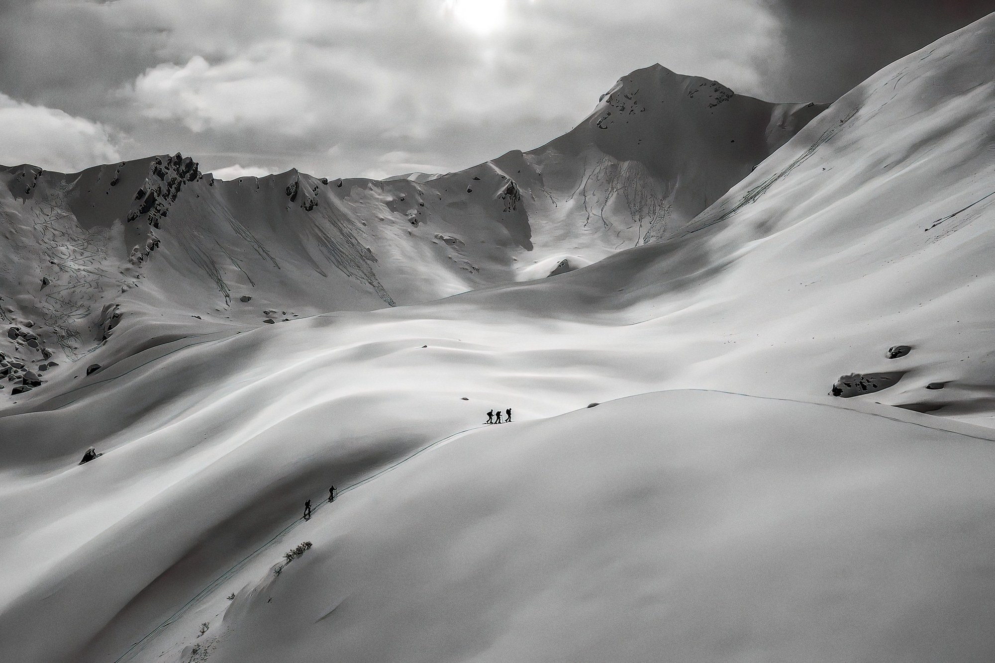 hikers walk on snow-covered mountains 