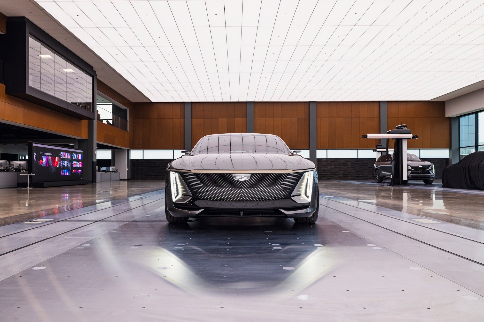 the grille of a black cadillac sedan in a large room