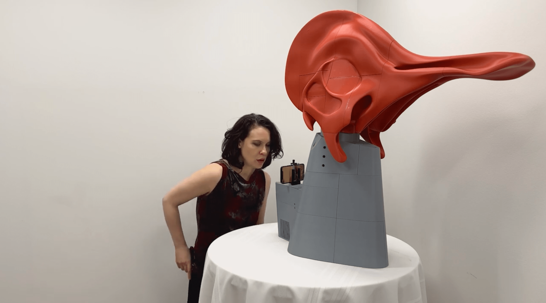 Woman demonstrating Dinosaur Choir invention