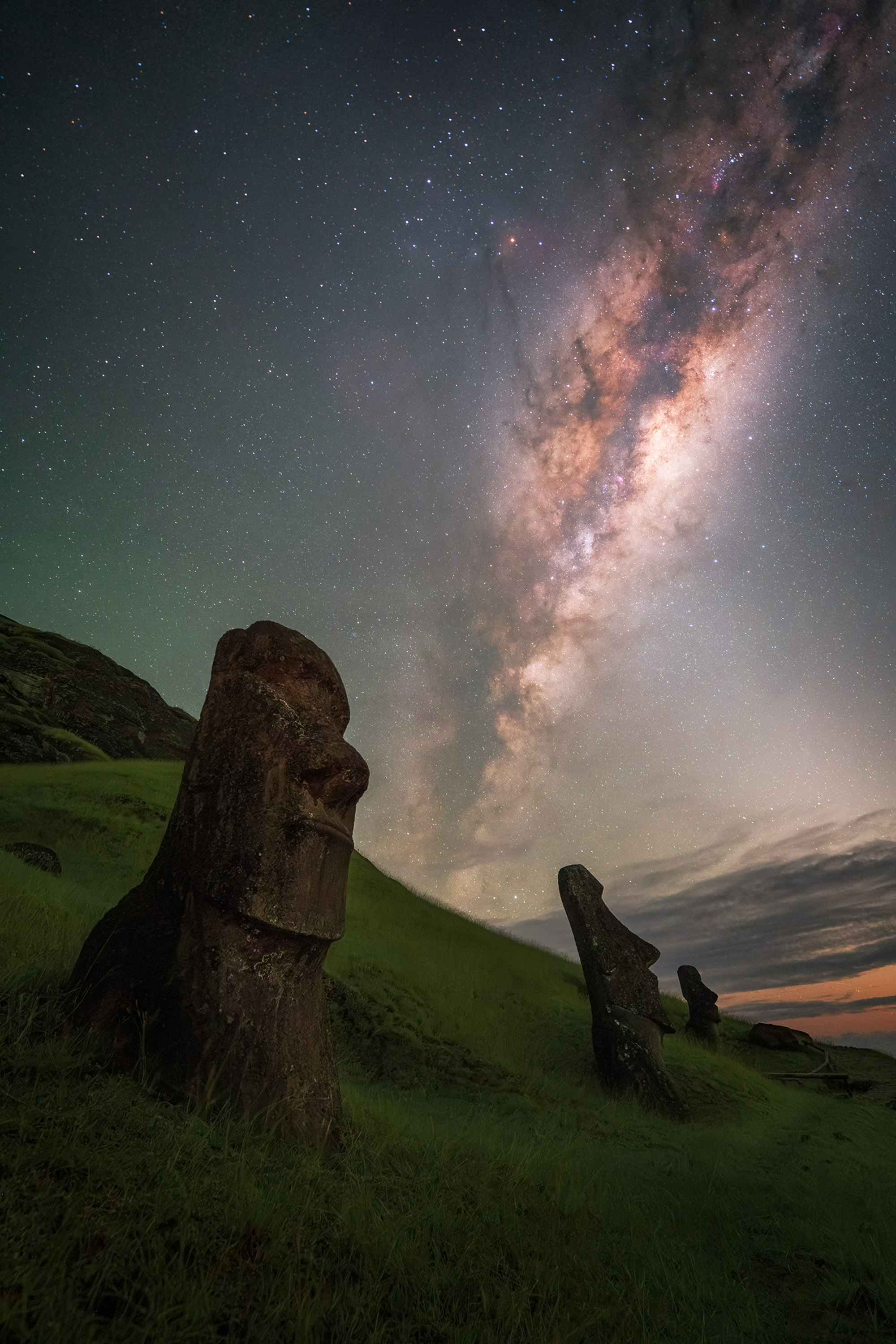 easter island heads on hillside under stars