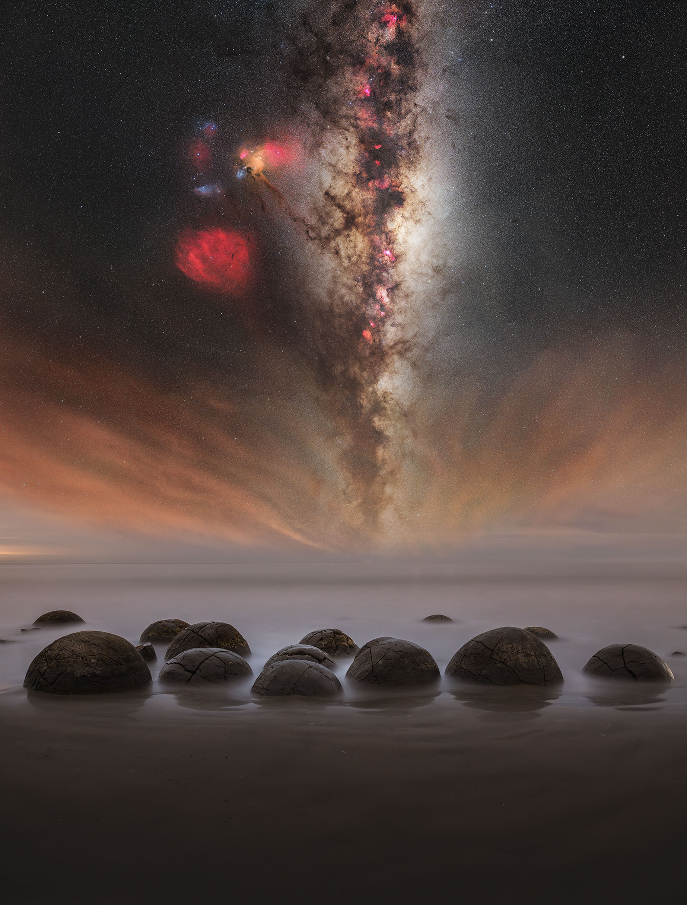 rounded stones in foreground with line of milky way above
