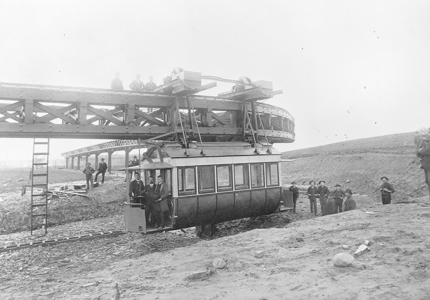 people stand on and near the First Electric Overhead Railroad in Minnesota