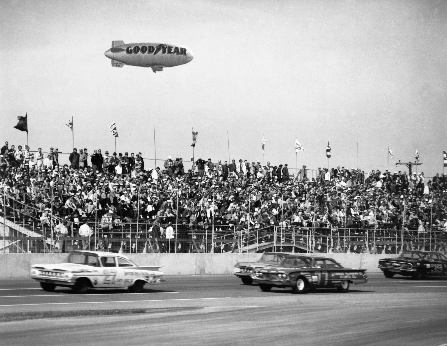 The Goodyear Blimp Mayflower flies over a NASCAR stock car event in 1963.