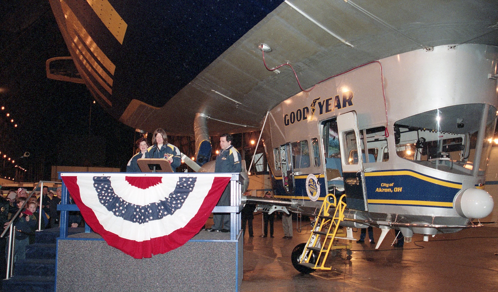 sally ride stands at podium with blimp behind her