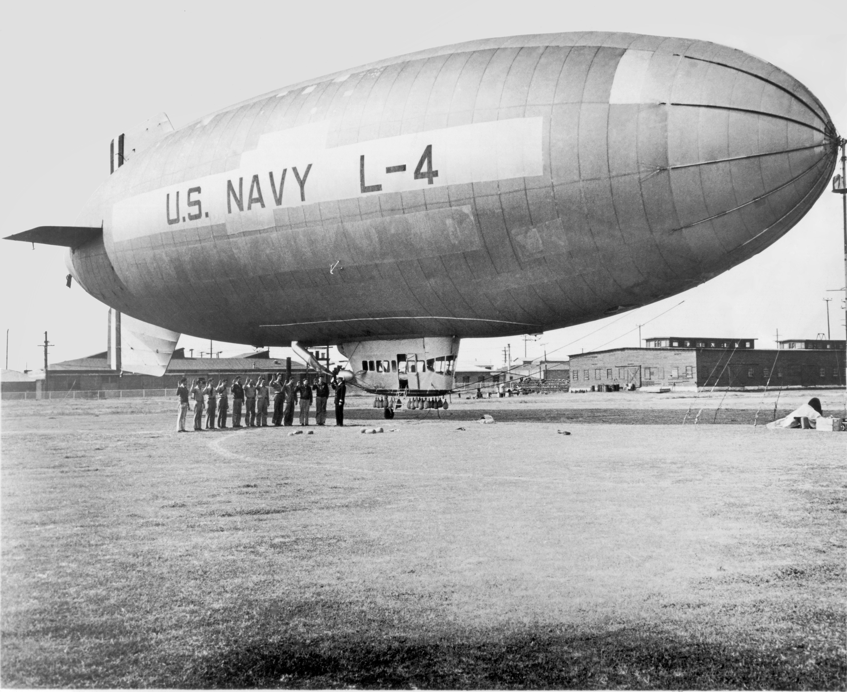 us navy branded blimp and its crew