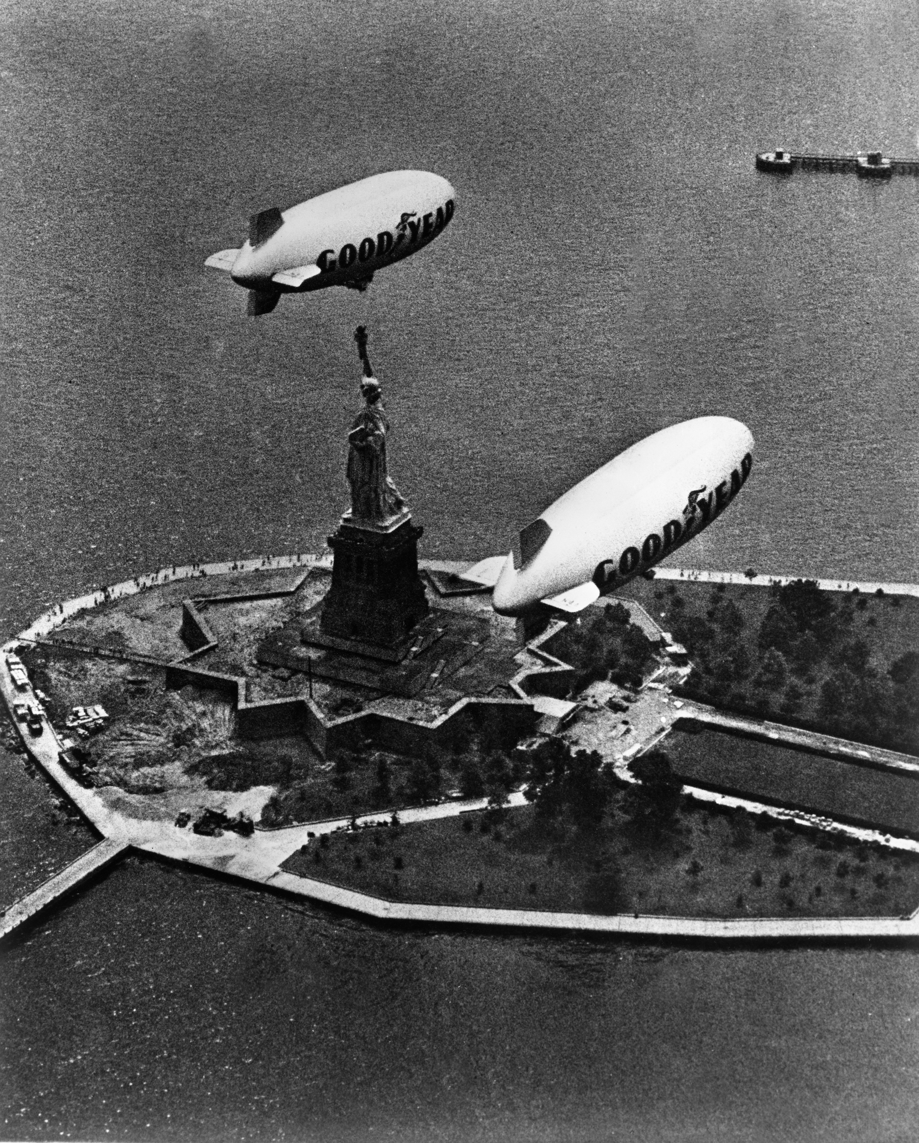 Goodyear Blimps Columbia and Mayflower fly over the Statue of Liberty