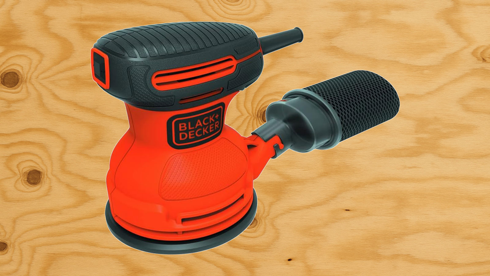  A Black & Decker sander in front of plywood.