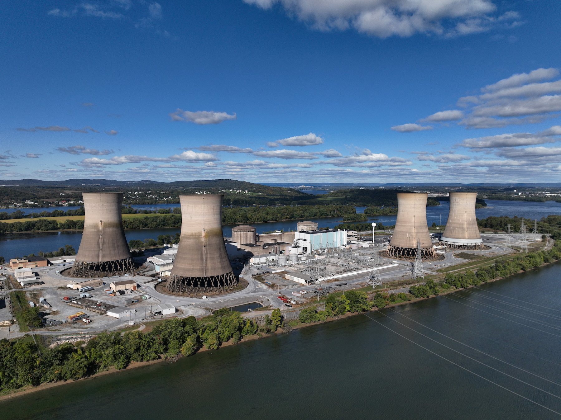 in this aerial view, the shuttered Three Mile Island nuclear power plant stands in the middle of the Susquehanna River