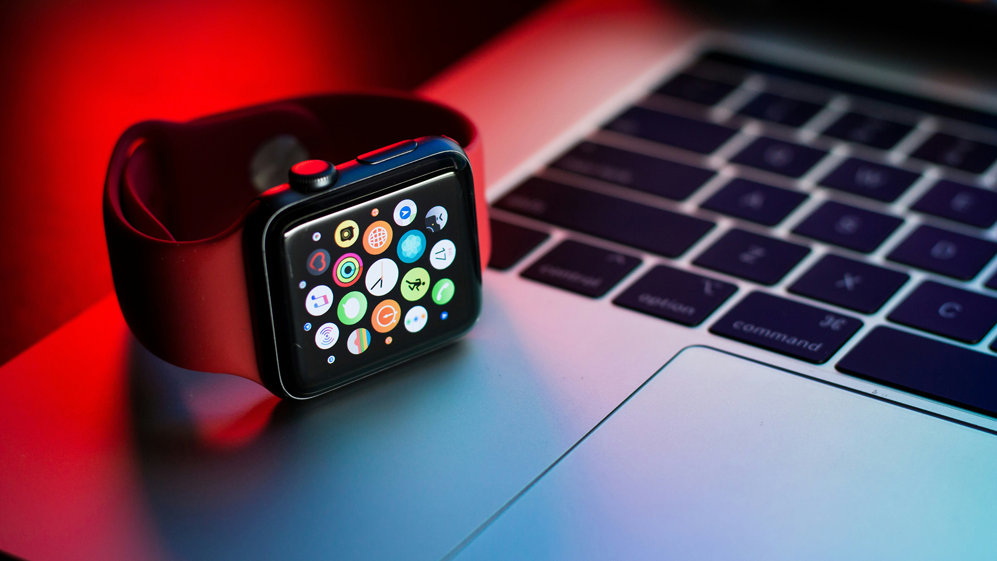 an apple watch sitting on a laptop