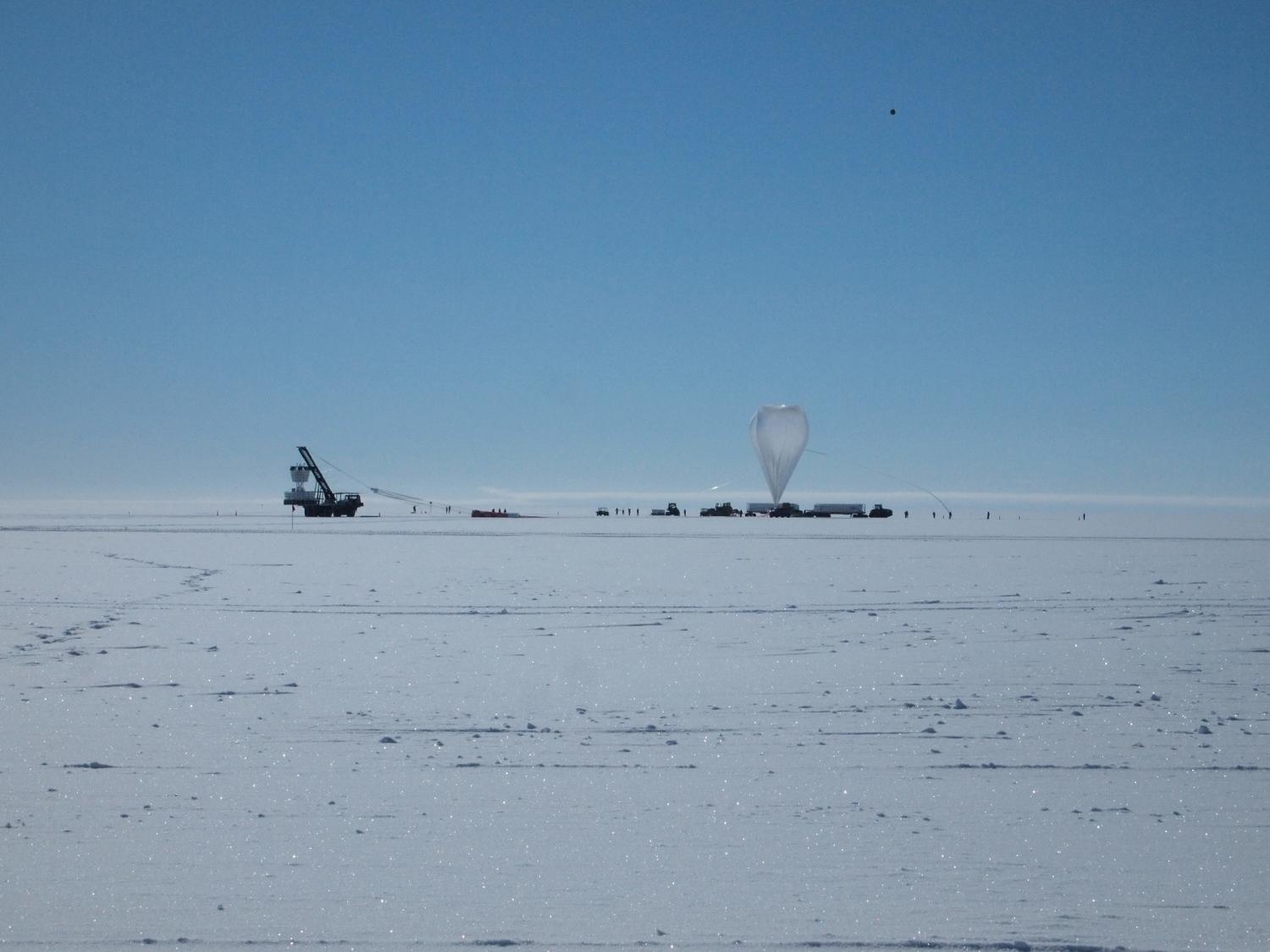 Far away shot of ANITA balloon system and trucks in Antarctica