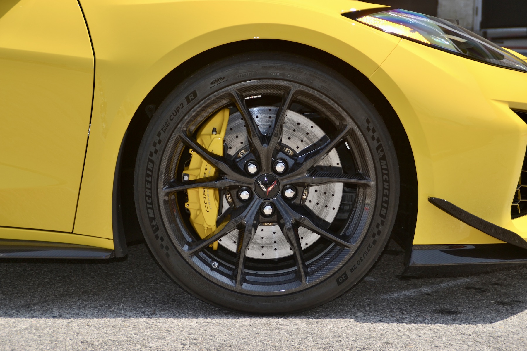 the front tire of a bright yellow sports car