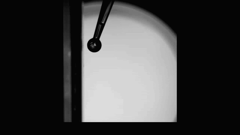 GIF of orb rolling vertically down glass surface