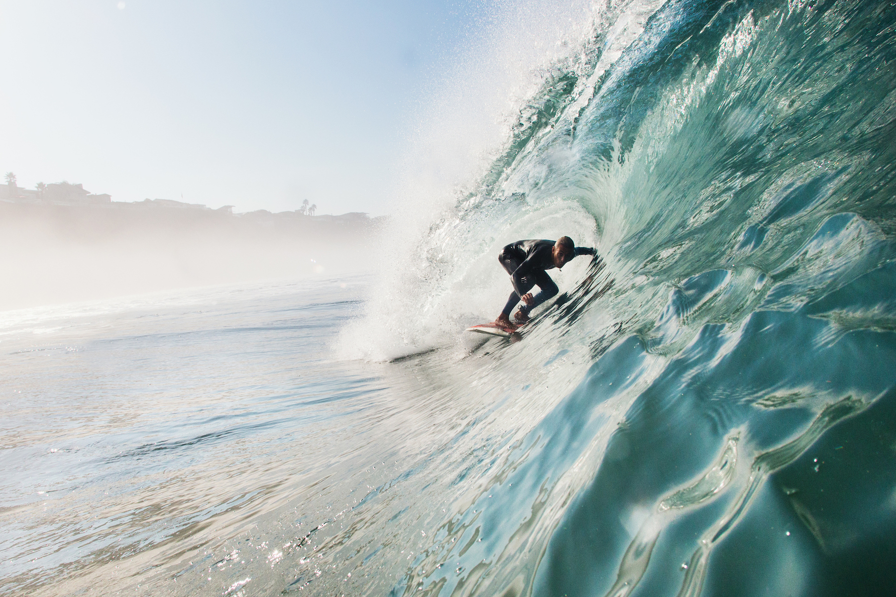a surfer inside the barrel of a wave