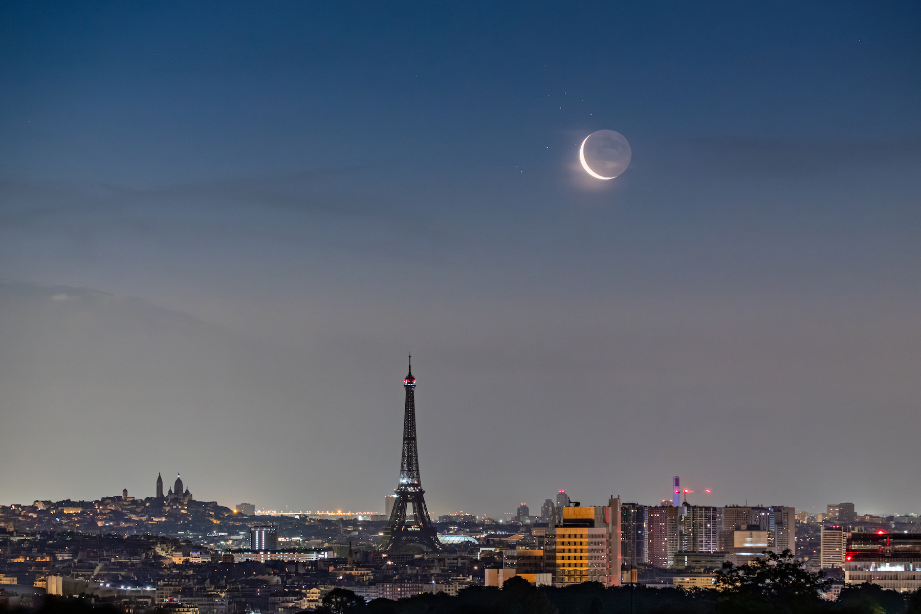a crescent moon over paris