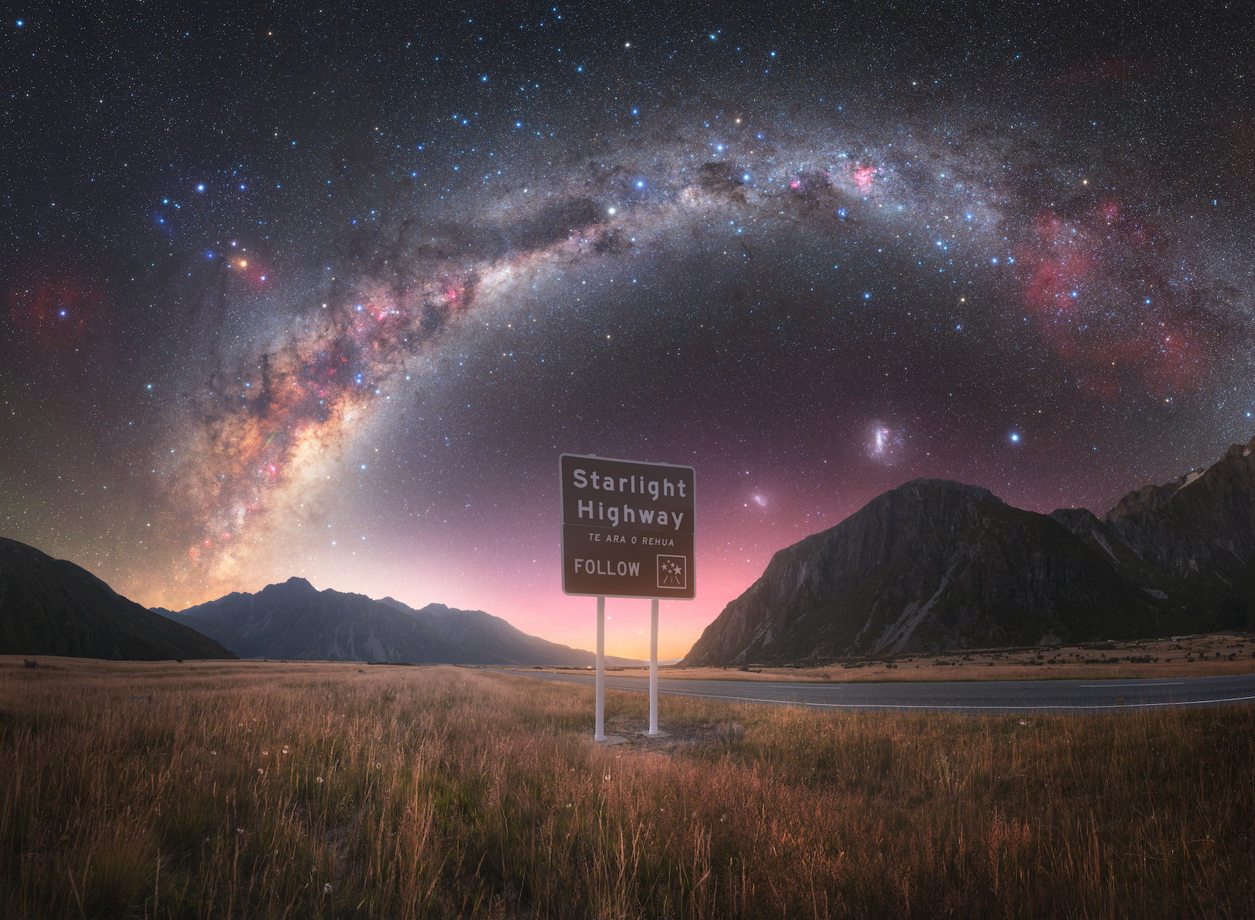 a sign that says 'starlight highway'. over the sign, the milky way stetches over the sky