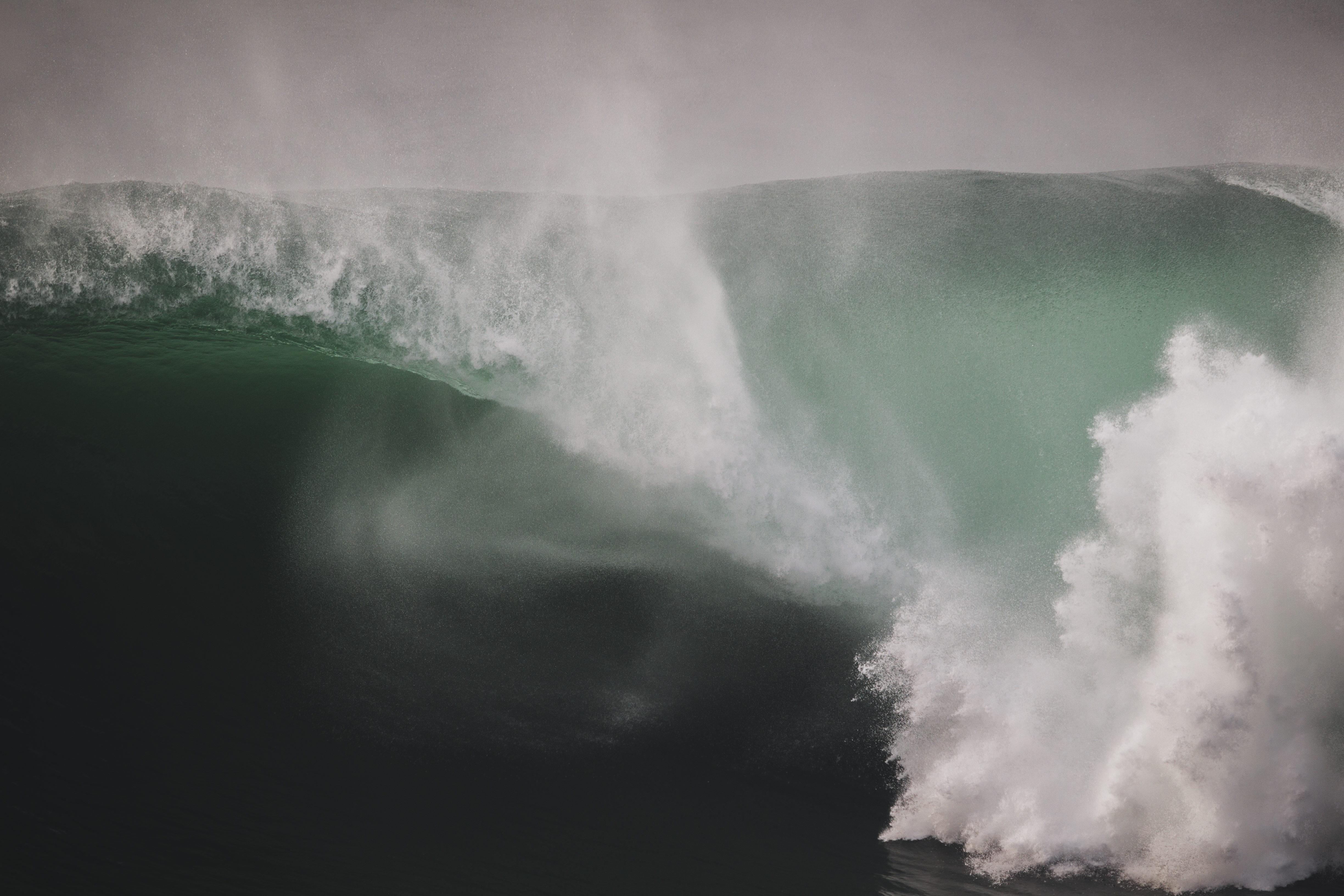 a large wave with barreling white water