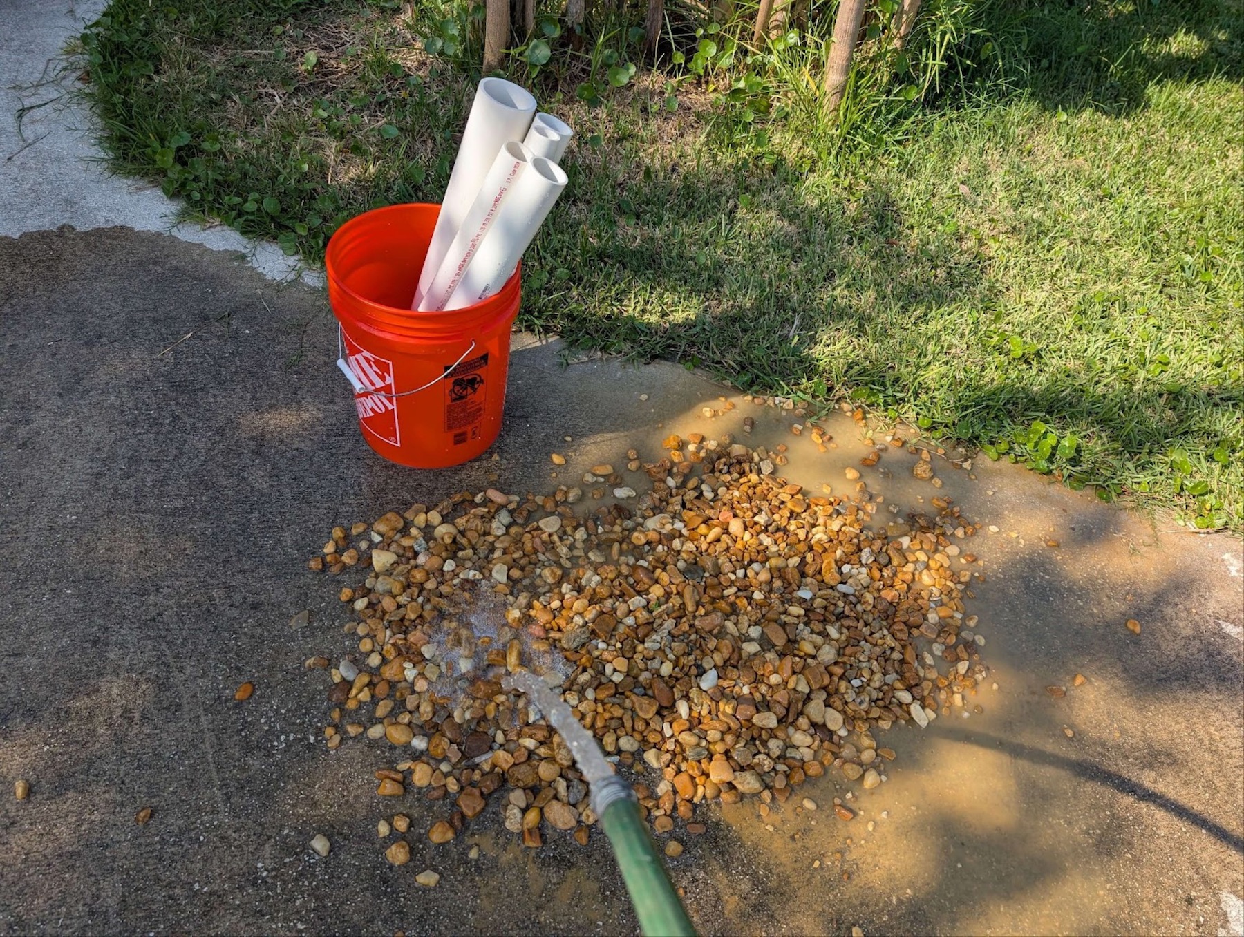 a hose spraying rocks