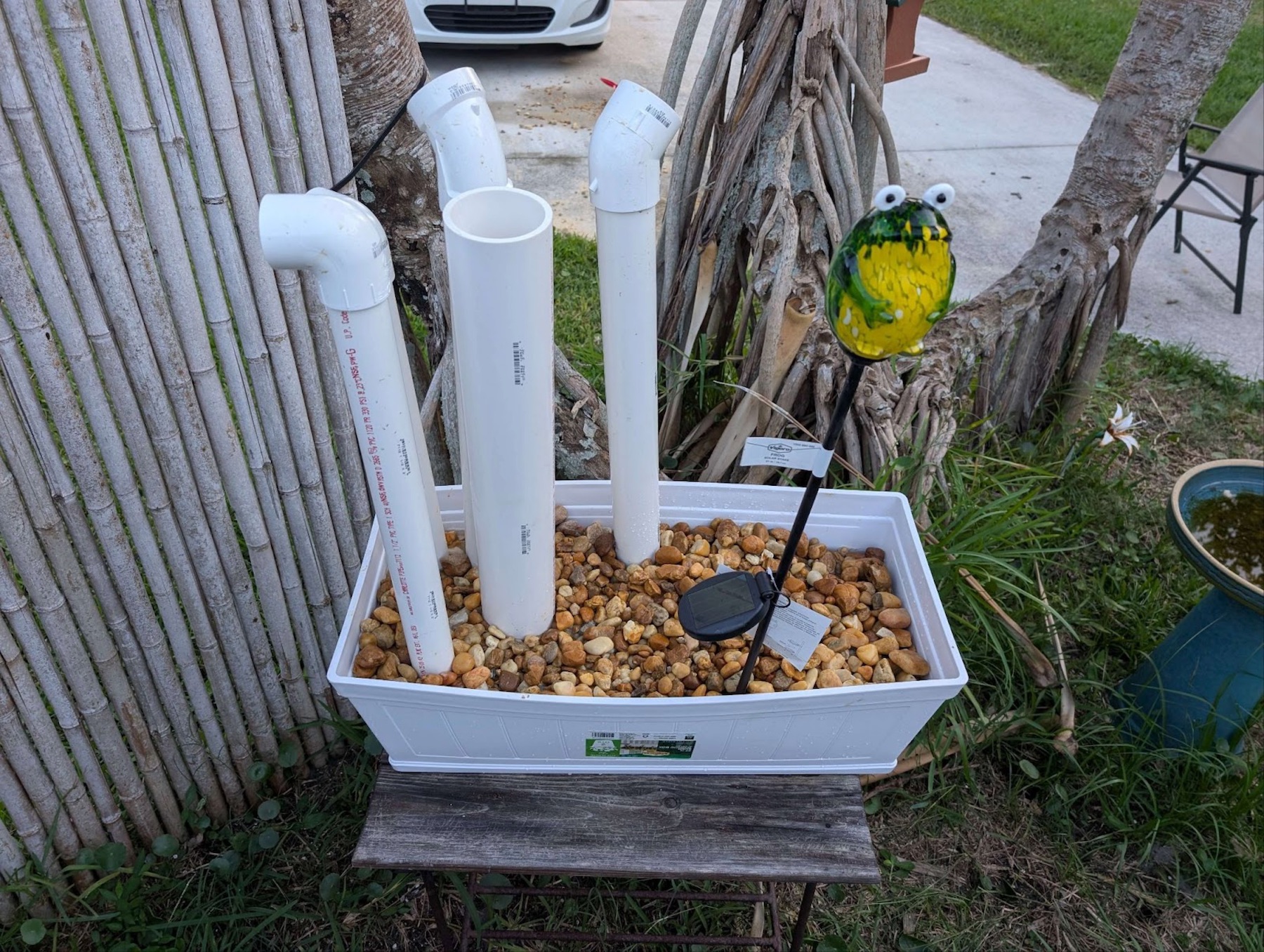 a frog hotel made from planters and pipes