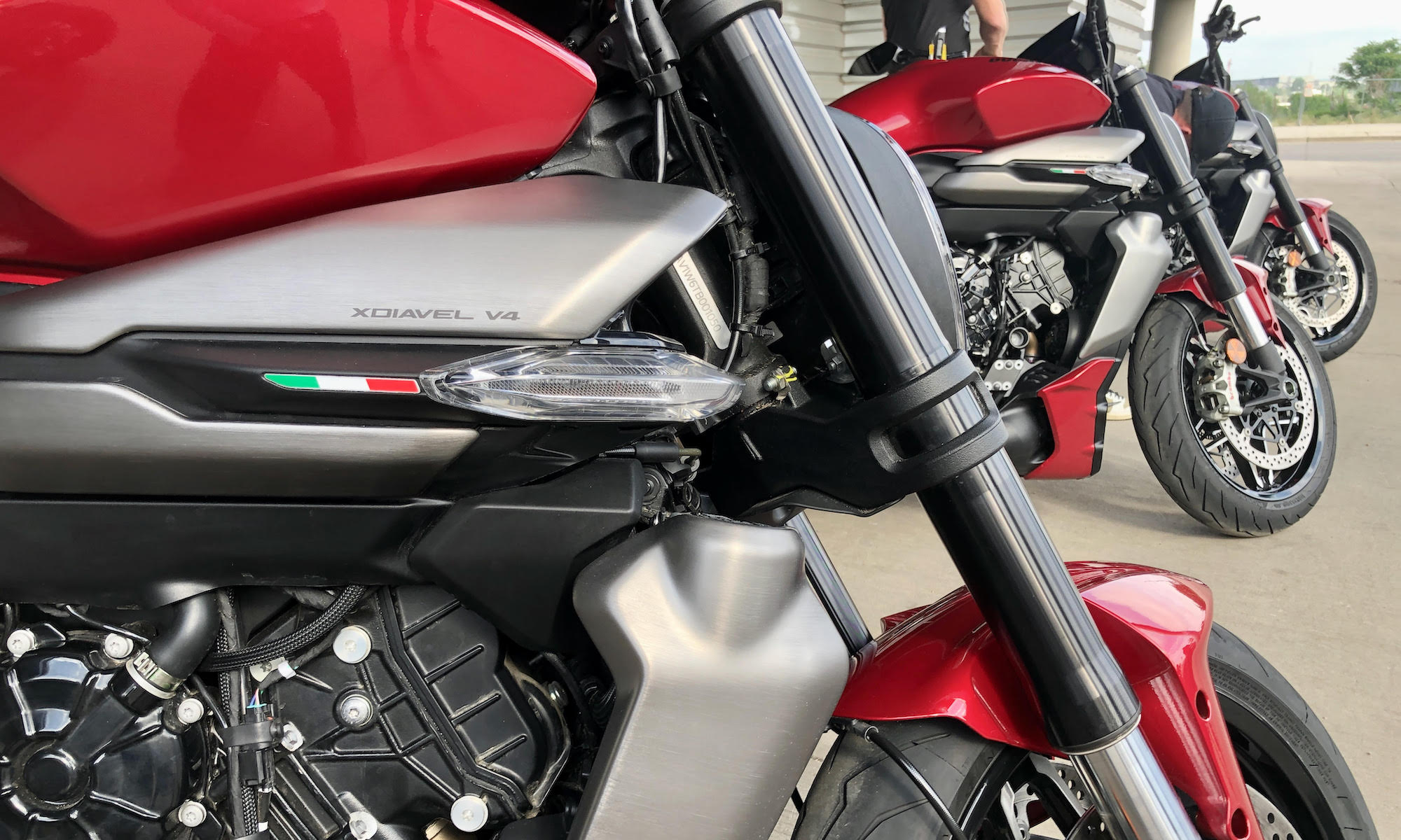 lineup of motorcycles. in focus is a turn signal on the central part of the bike