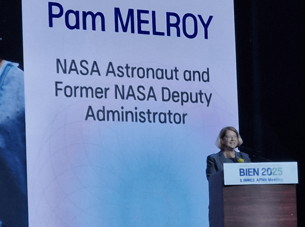 woman stands at podium