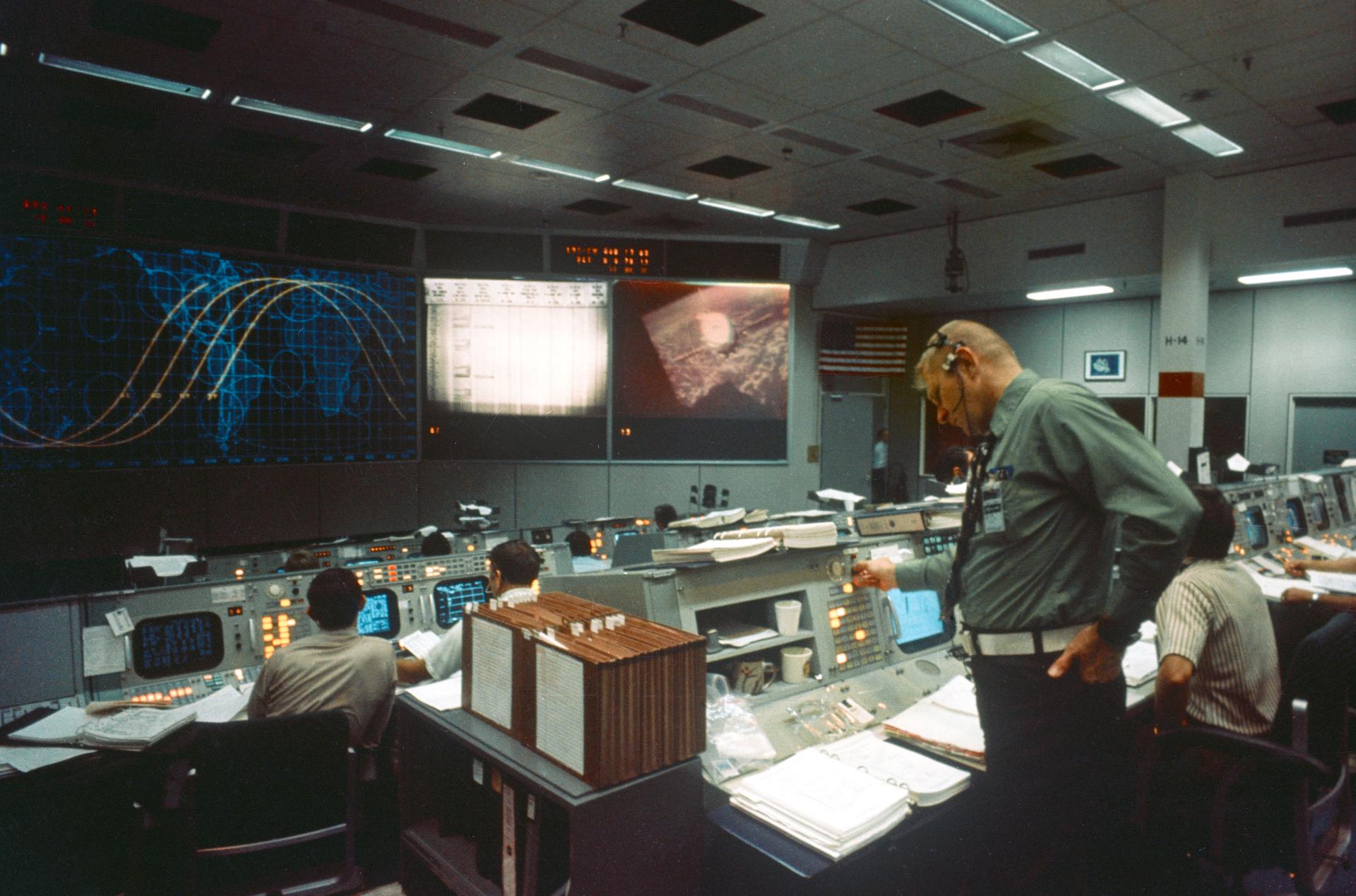 a man stands in mission control