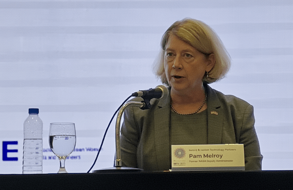 middle aged woman speaks into a microphone