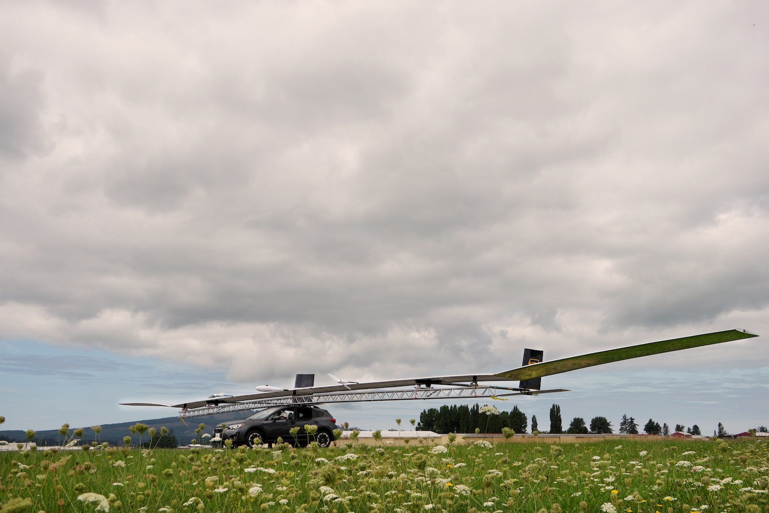 a long, thin drone on top of an SUV