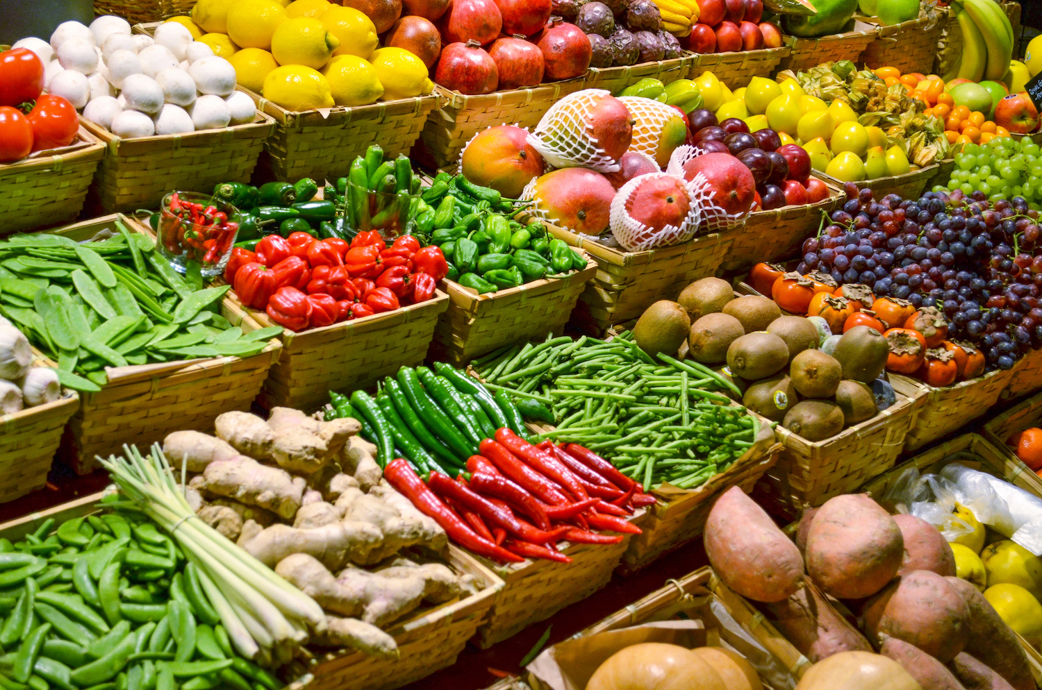 fruits and vegetables in baskets at a grocery store