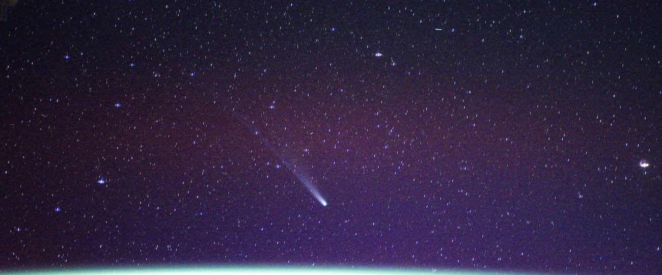 ISS astronauts photograph two comets soaring over Earth’s auroras