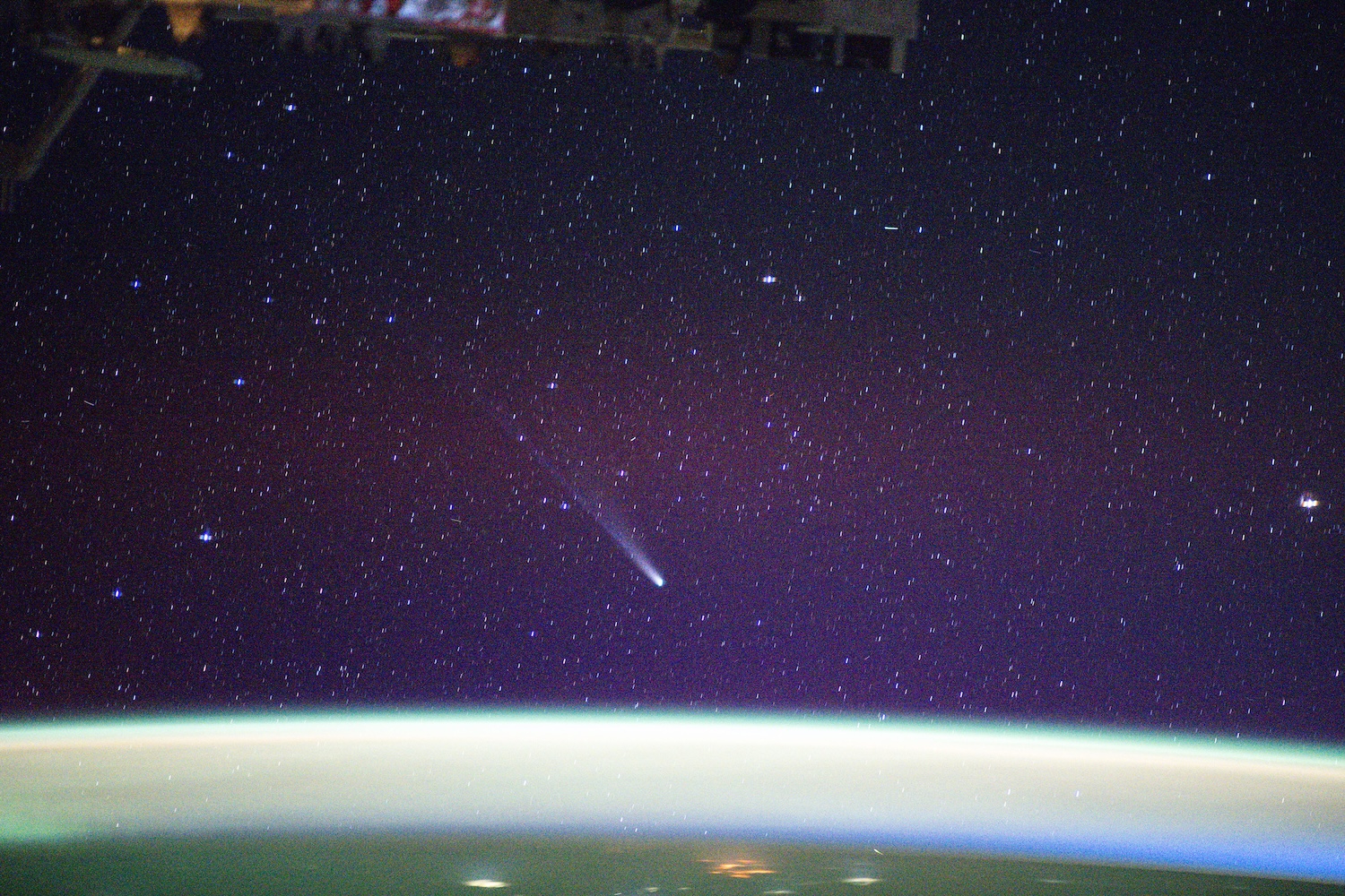 Comet traveling over Earth aurora