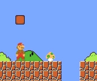 Super Mario uncovering the first 1-Up mushroom inside a hidden block right before the first pit in World 1-1 in Super Mario Bros. Screenshot: supermarioplay.com.