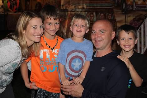 a family with two parents and three sons