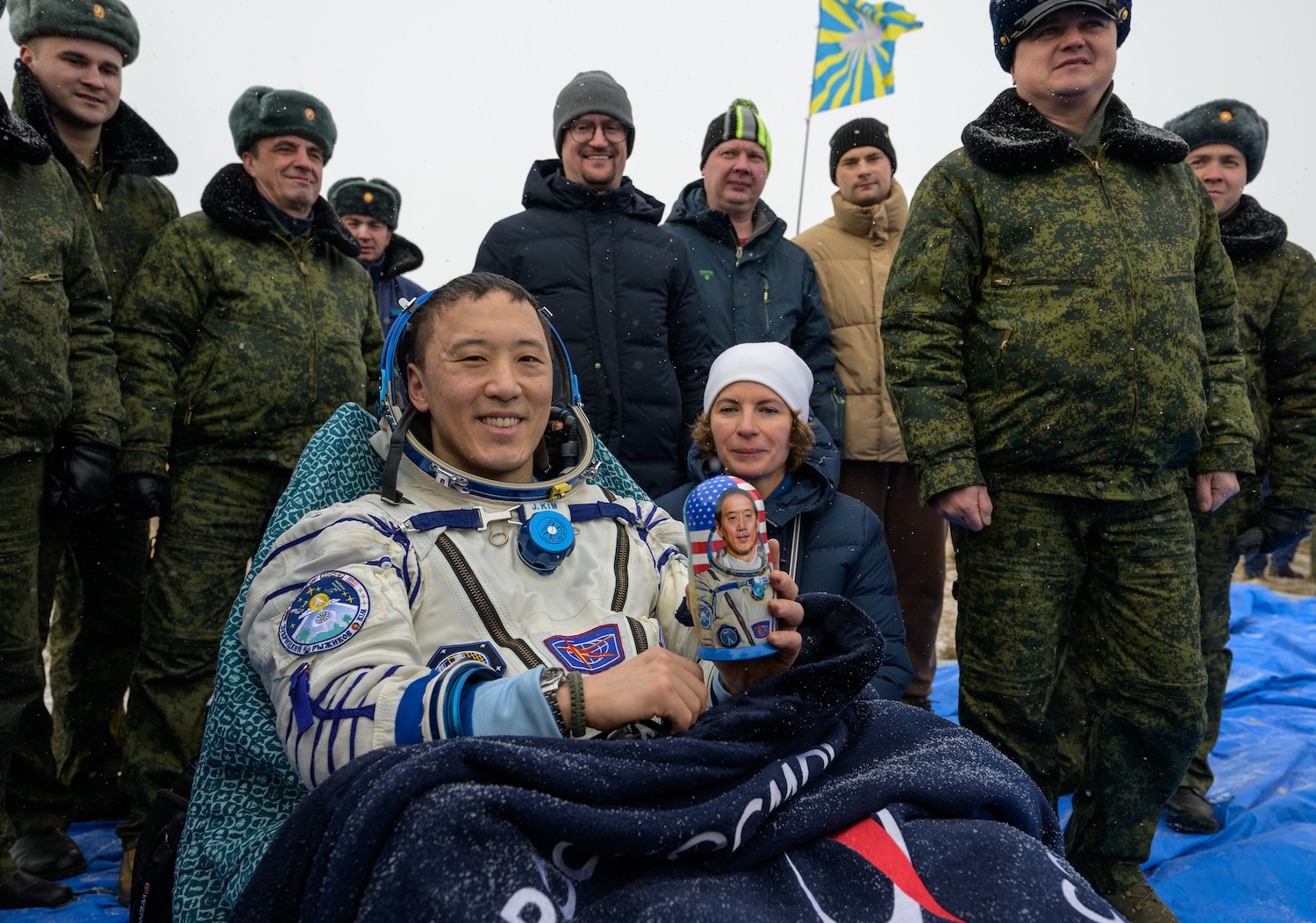 NASA astronaut Jonny Kim is seen outside the Soyuz MS-27 spacecraft, with a gifted Matryoshka Doll, after he landed with Roscosmos cosmonauts Sergey Ryzhikov, and Alexey Zubritsky in a remote area near the town of Zhezkazgan, Kazakhstan on Tuesday, Dec. 9, 2025. The trio returned to Earth after logging 245 days in space as a members of Expeditions 72 and 73 aboard the International Space Station. Photo Credit: NASA / Bill Ingalls