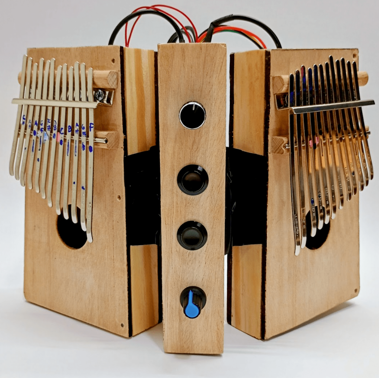 Wooden instrument with djembe-like musical attachments