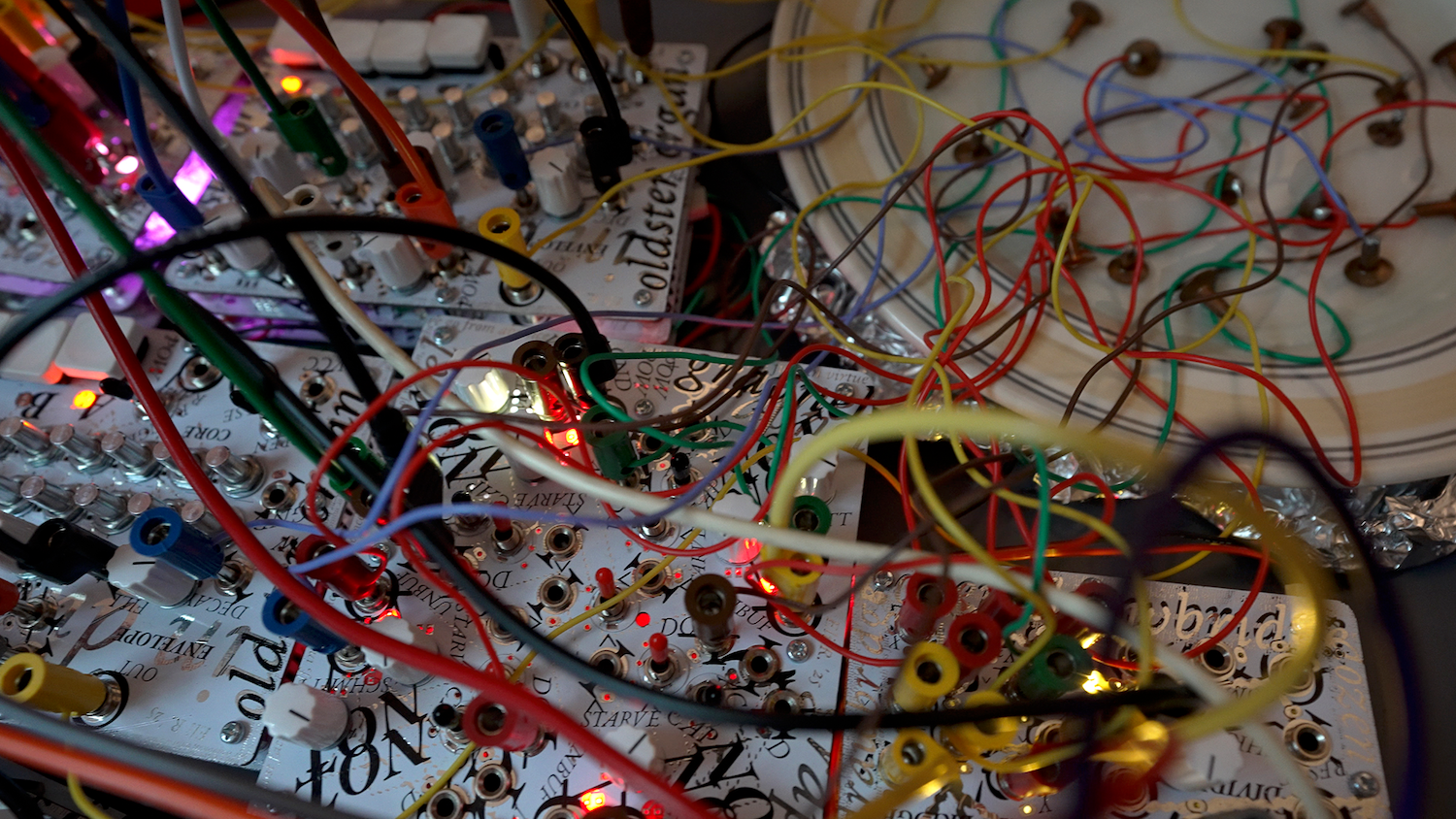 Close up of Amphibians Modules instgrument showing a tangle of multicolor synthesizer cables