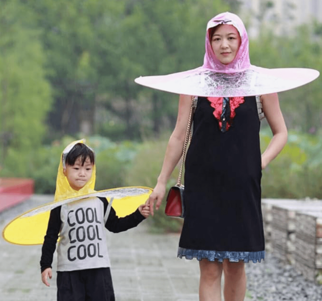 a mother and child with head umbrellas