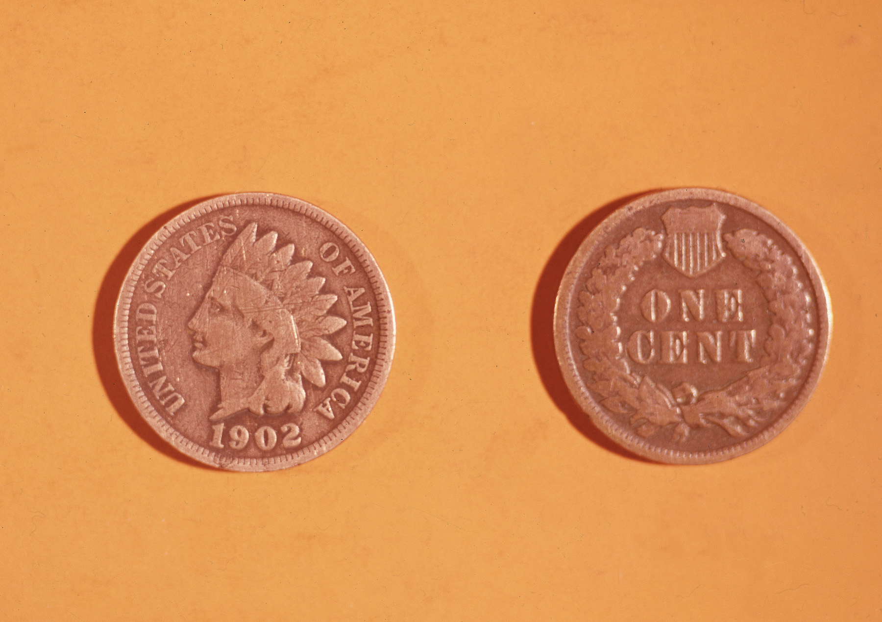 Front and back view of an American one cent coin, a 1902 'Indian Head' penny. The front (left) features profile of a feather-crowned Native American, while the reverse side features a wheat wreath and shield. (Photo by Lambert/Getty Images)
