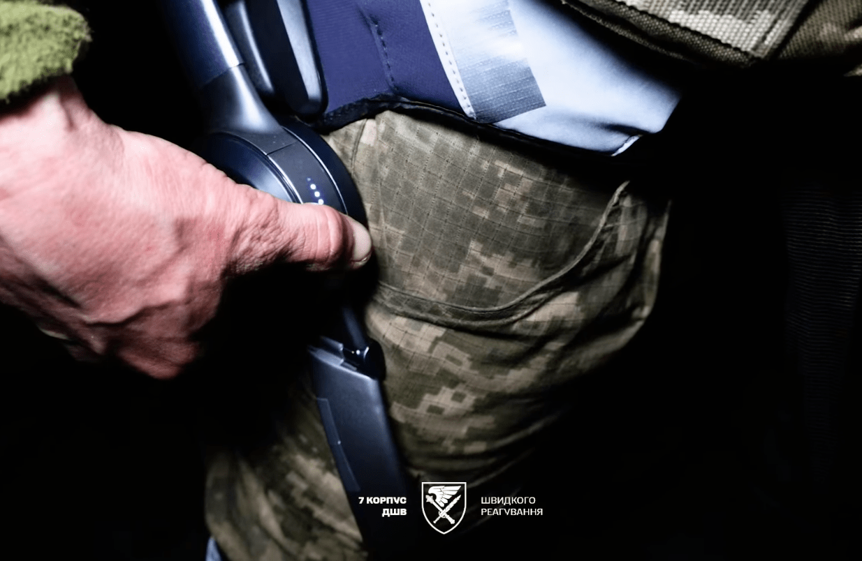 a close up of the strap of an exoskeleton on a soldier's leg