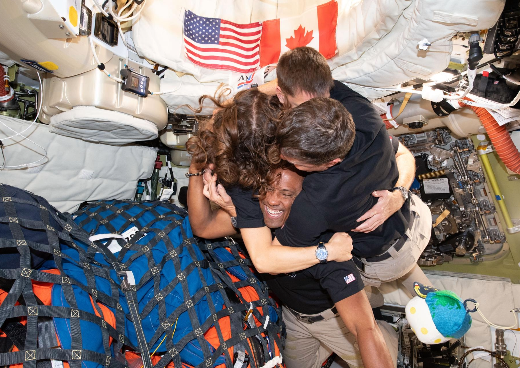 Four astronauts hugging in space. The Artemis II crew – (clockwise from left) Mission Specialist Christina Koch, Mission Specialist Jeremy Hansen, Commander Reid Wiseman, and Pilot Victor Glover – take time out for a group hug inside the Orion spacecraft on their way home. Following a swing around the far side of the Moon on April 6, 2026, the crew exited the lunar sphere of influence (the point at which the Moon's gravity has a stronger pull on Orion than the Earth's) on April 7, and are headed back to Earth for a splashdown in the Pacific Ocean on April 10. The crew was selected in April 2023, and have been training together for their mission for the past three years. 
