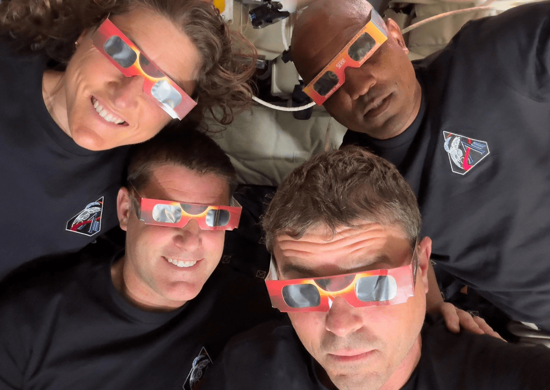 The Artemis II crew—Mission Specialist Christina Koch (top left), Mission Specialist Jeremy Hansen (bottom left), Commander Reid Wiseman (bottom right), and Pilot Victor Glover (top right)—uses eclipse viewers, identical to what NASA produced for the 2023 annular eclipse and 2024 total solar eclipse, to protect their eyes at key moments during the solar eclipse they experienced during their lunar flyby. This was the first use of eclipse glasses at the Moon to safely view a solar eclipse.